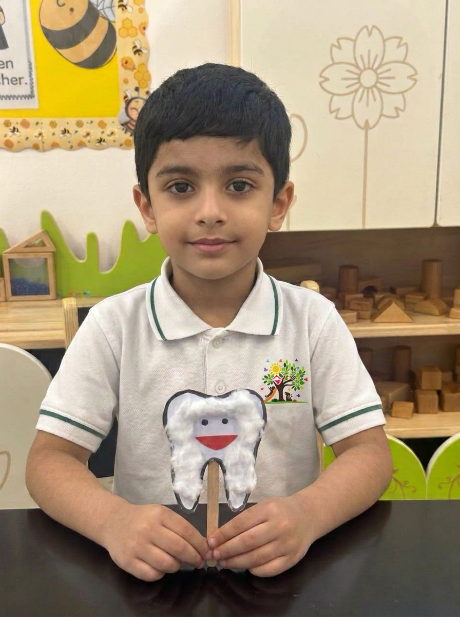 A child holding up a cotton-wool tooth puppet